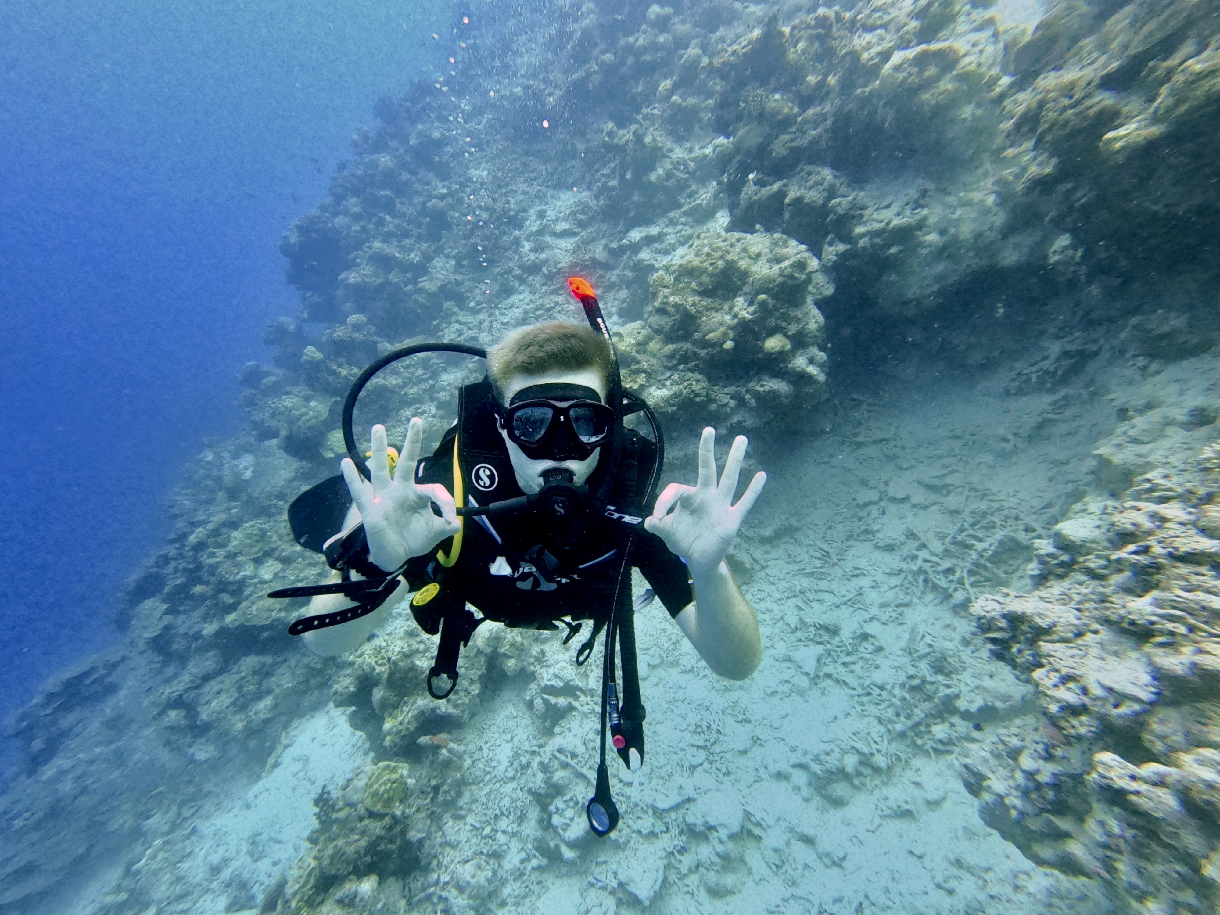 Sam on one of his first open water dives in the Maldives, marking the start of his scuba journey.